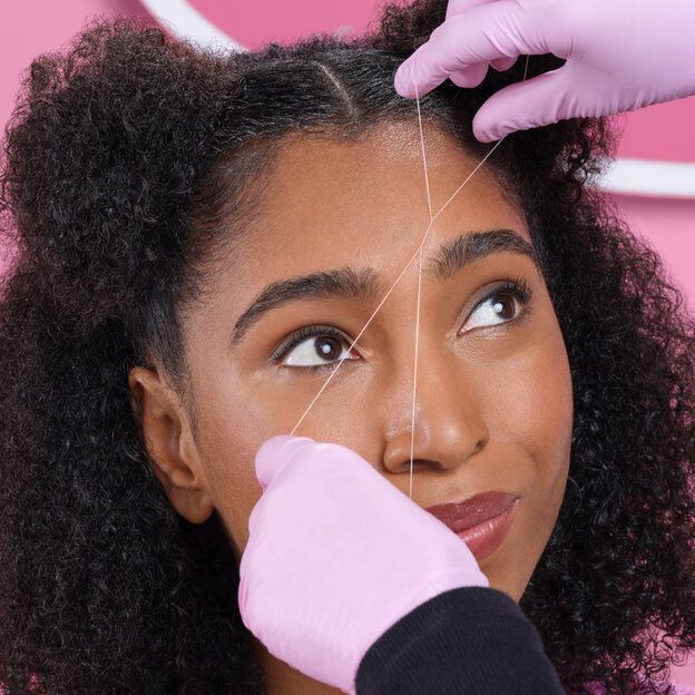 Girl getting Brow Threading